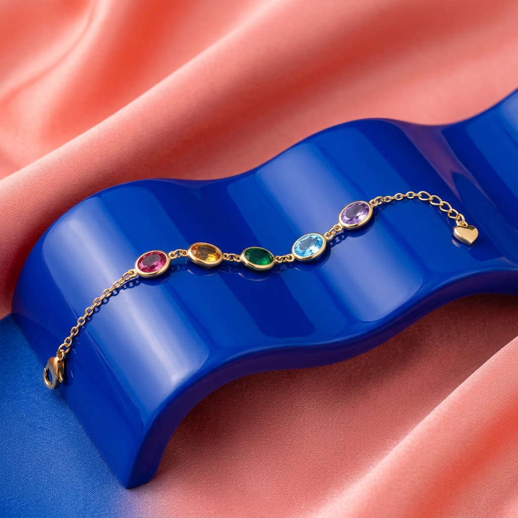 Multicolor oval bracelet arranged on a cobalt-blue pedestal against coral fabric