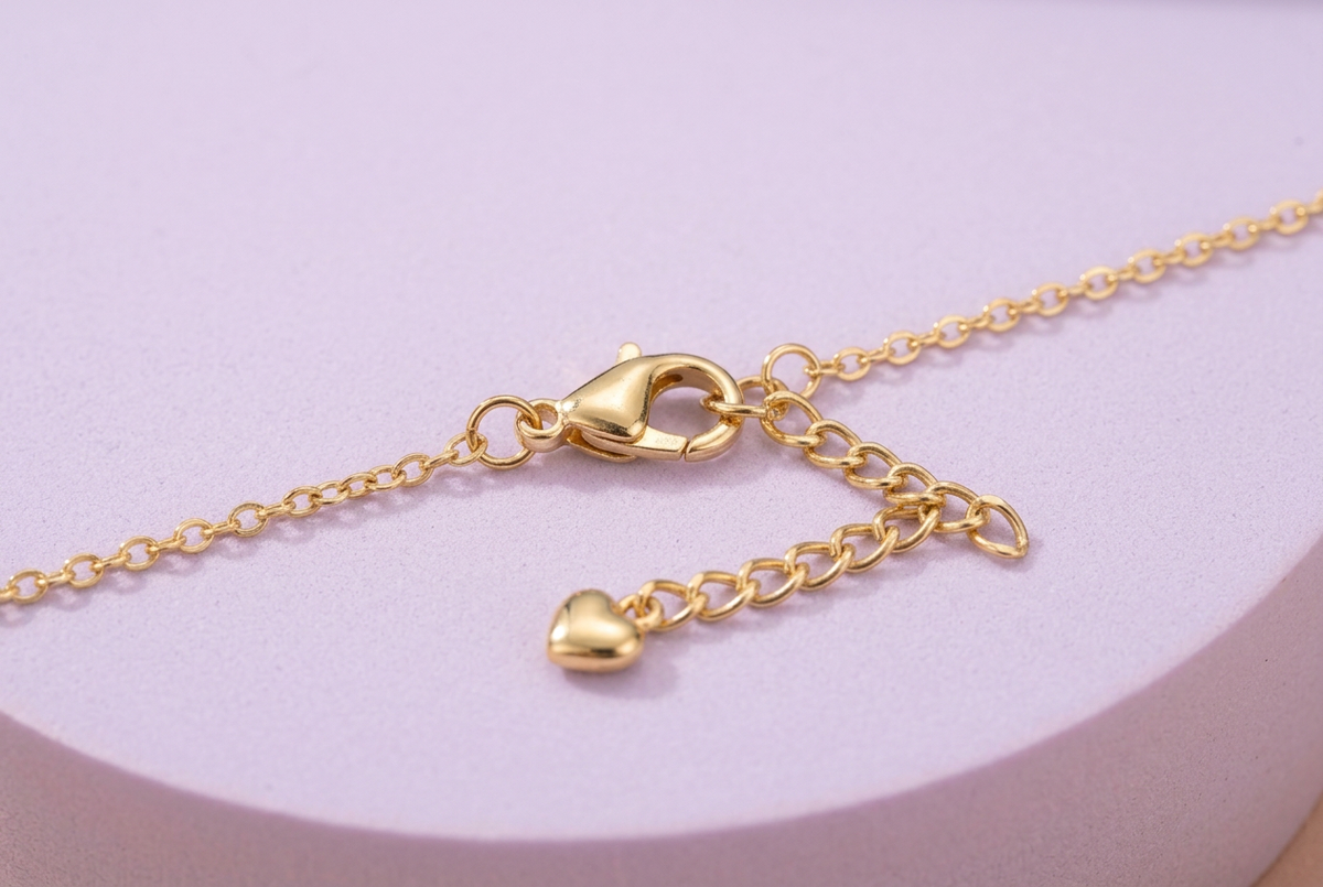 Necklace lobster-style clasp and extension ending in a small heart