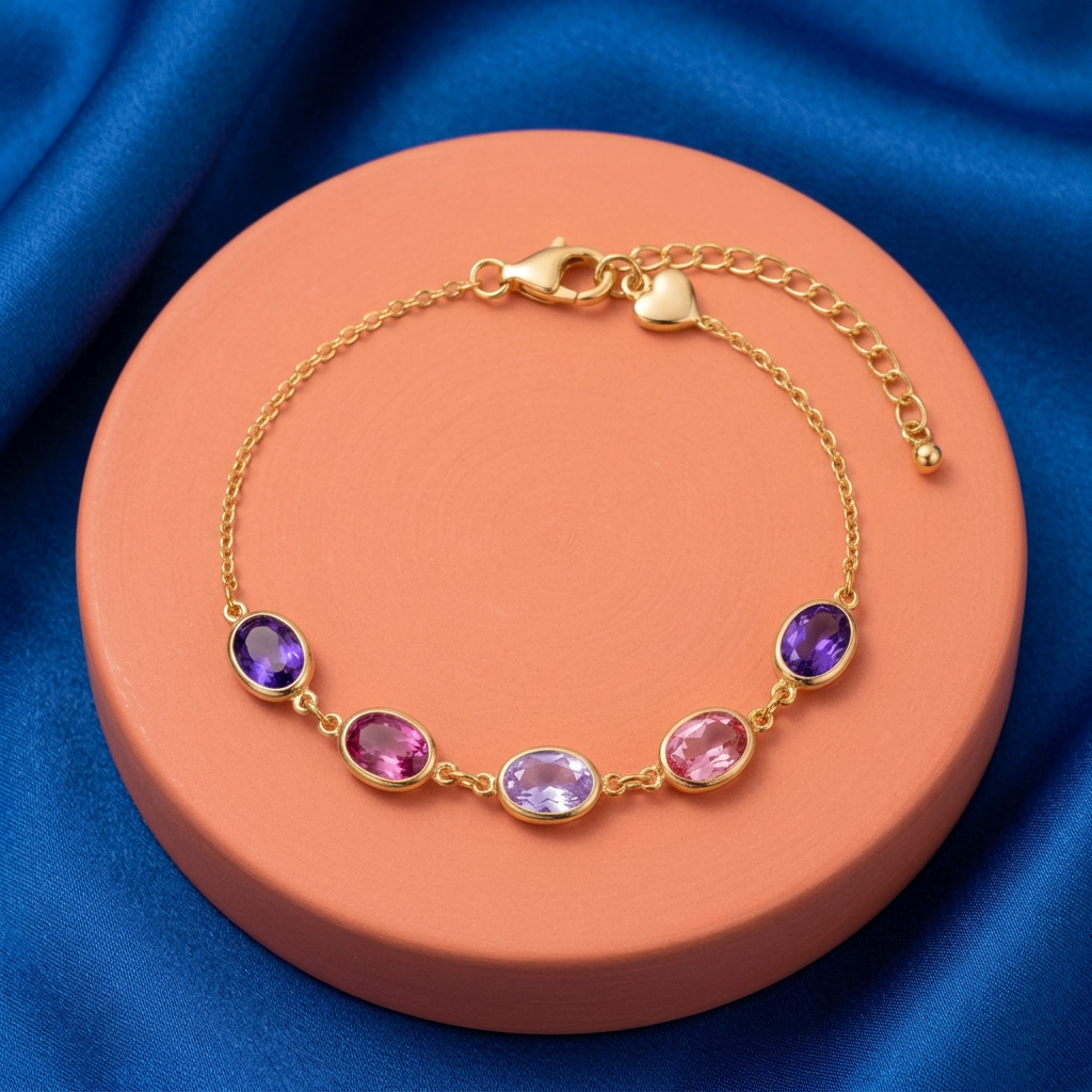 Purple pink bracelet on coral pedestal against cobalt silk