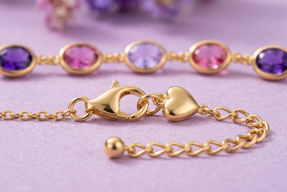 Close-up of gold-tone lobster-style clasp heart charm and extension links