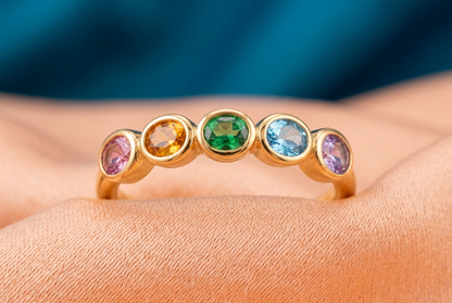 Macro of pink amber green blue lavender oval accents across ring top
