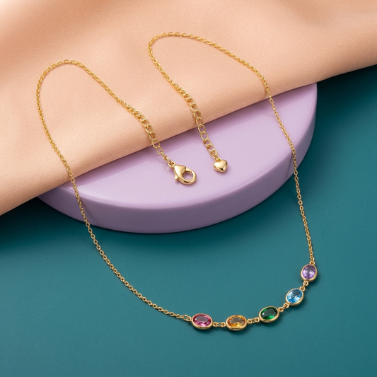 Prism Garden five-color oval necklace with long gold-tone chain on peach and teal