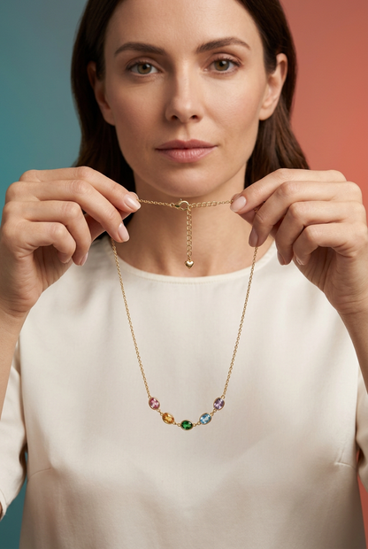 Brunette model in ivory holding the necklace by upper chain sides