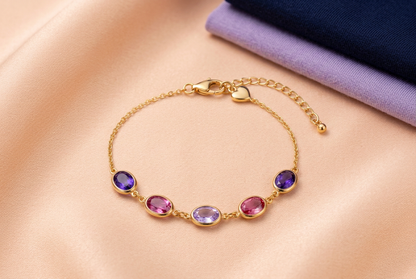 Complete Lilac Reverie bracelet on peach fabric beside navy and lavender garments